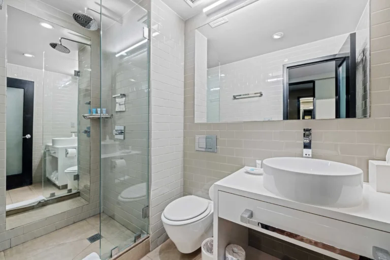 A clean bathroom with a shower, toilet, and vanity.
